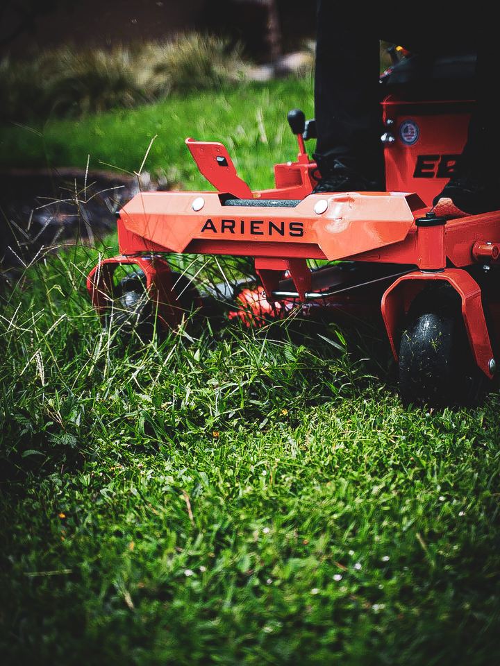 Mower deck cutting through the grass, close up